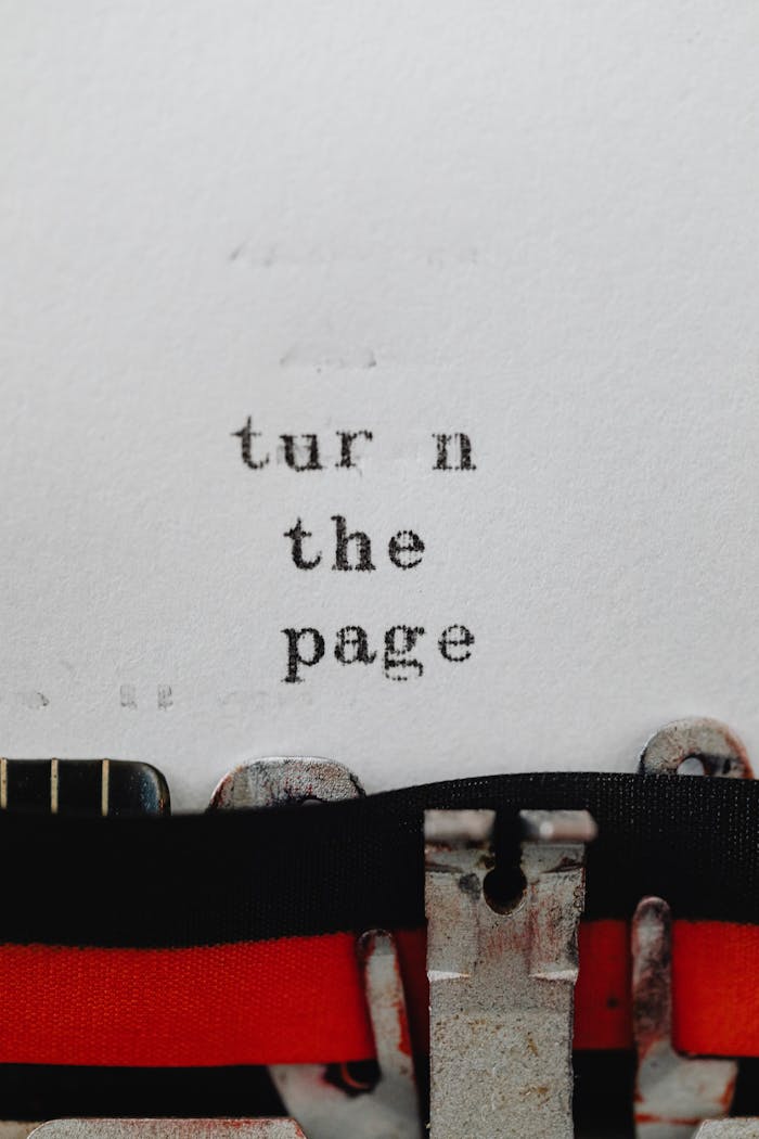 Close-up of a vintage typewriter with the phrase turn the page on paper.