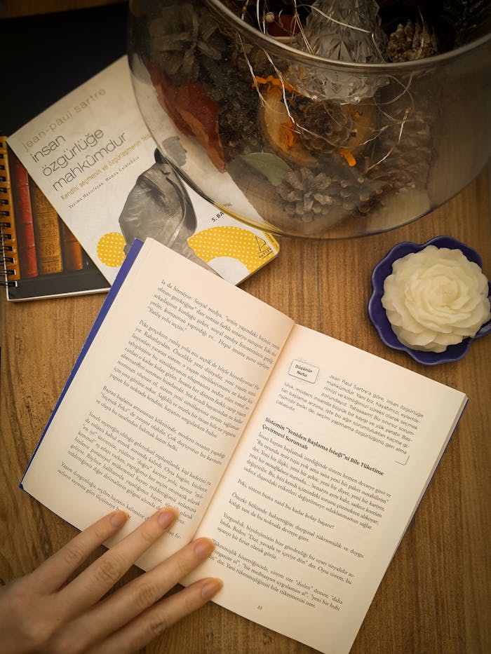 A warm, inviting scene featuring an open book and decorative items on a wooden table, perfect for cozy moments.