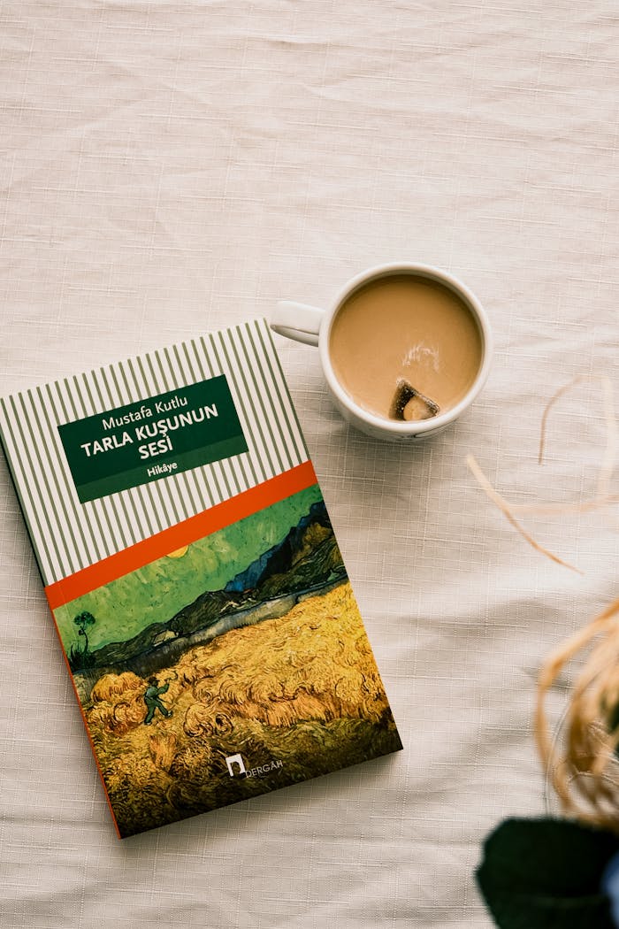 A book and coffee on a textured surface creating a cozy reading atmosphere.